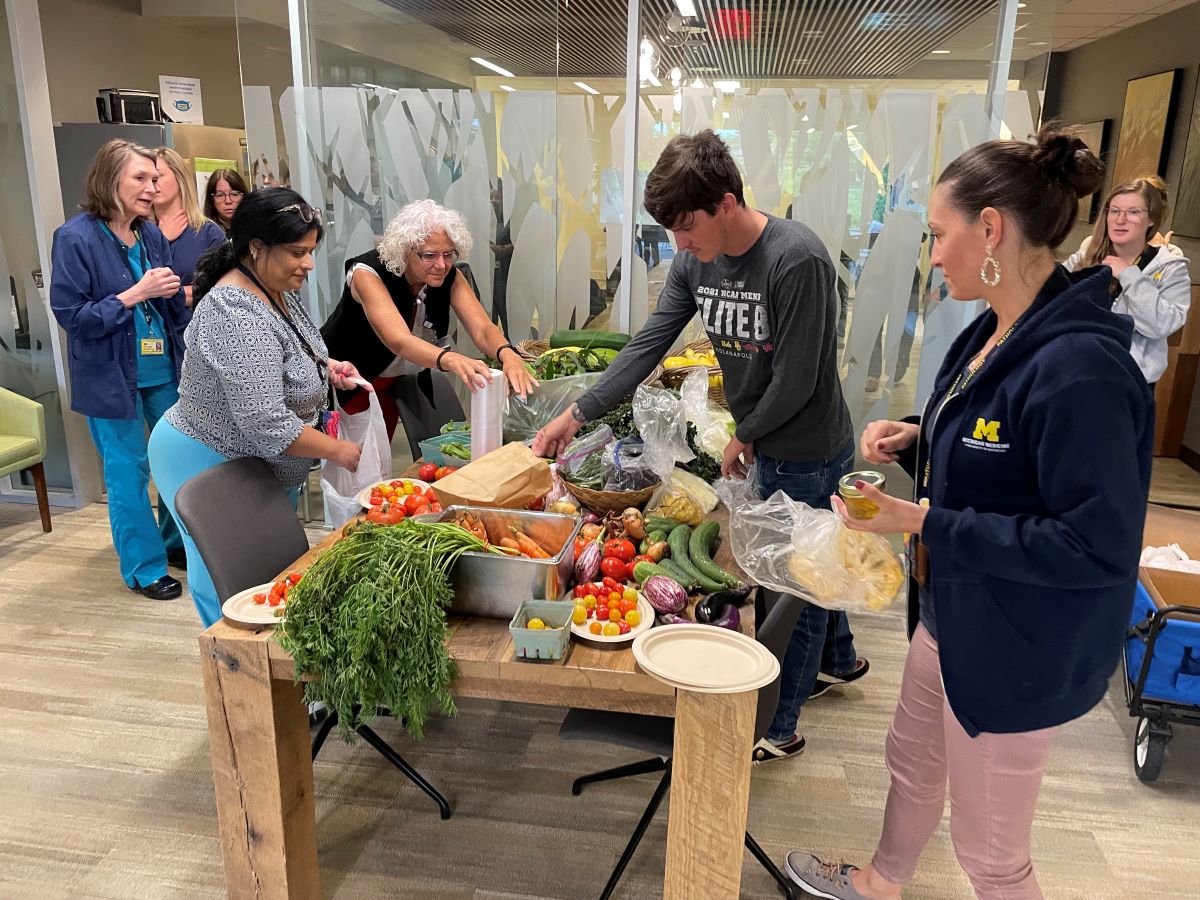 Pathology employees eagerly claim their vegetables at the NCRC.